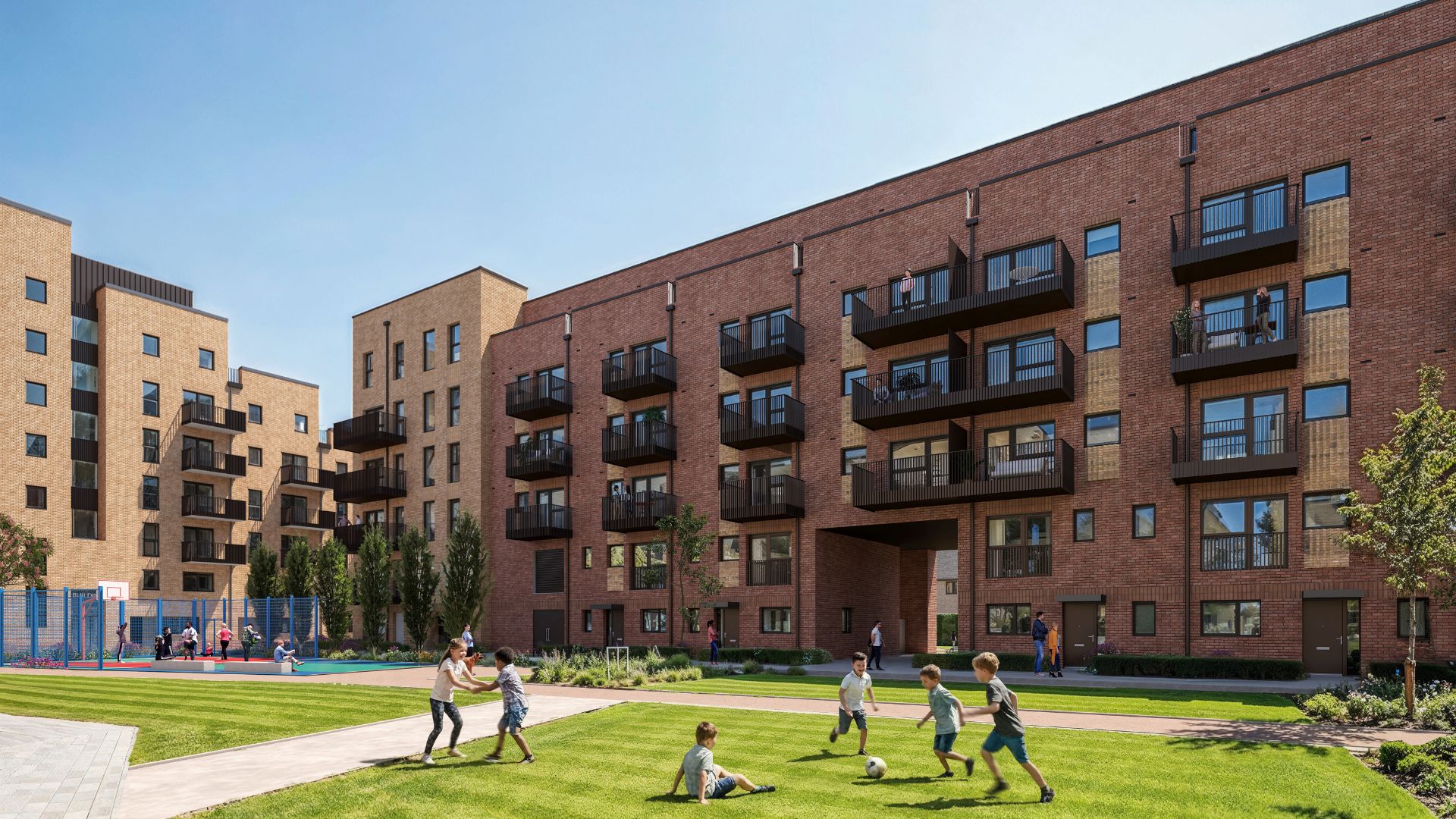 Modern apartment blocks with brick façades and balconies overlooking a shared green courtyard, where children play on grass and a basketball court sits in the background.
