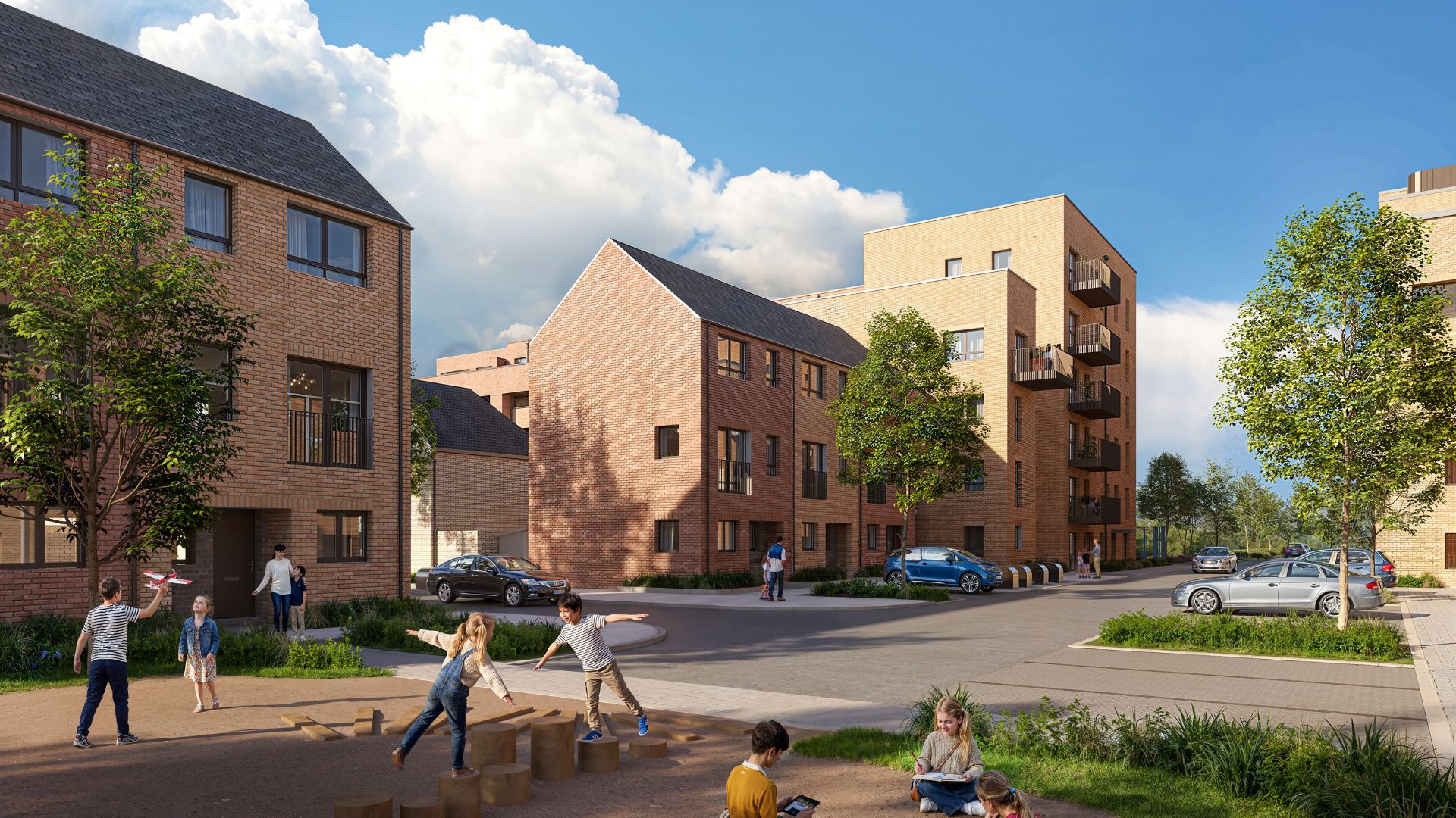 New-build residential development with brick houses and apartments, featuring a landscaped courtyard where children play and families gather, with parked cars and trees under a blue sky