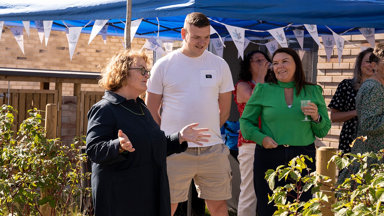 Clarion Housing Group's CEO, Clare Miller, speaking to residents and colleagues at a community event celebrating the milestone of them moving to their new homes.