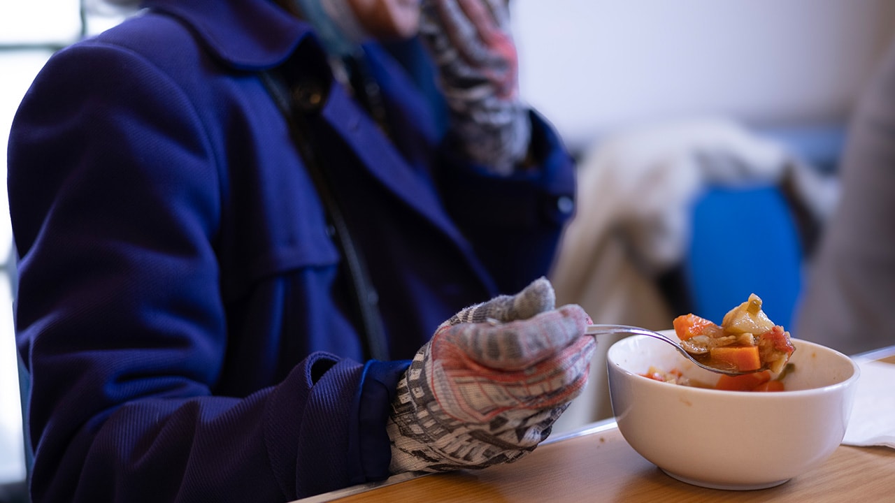 Woman enjoying a meal at community organisation