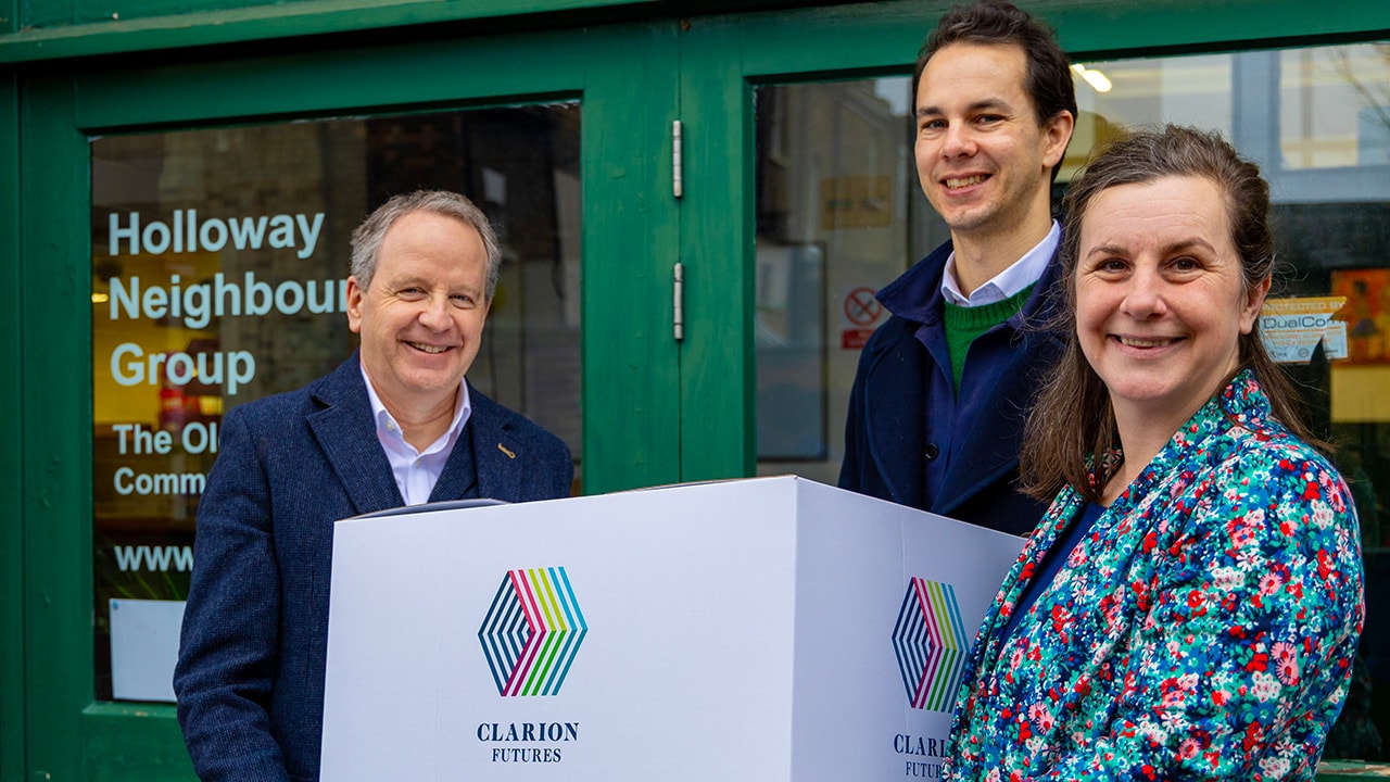 Phil Miles (Director of Clarion Futures), Tom Neumark (Trustee of Holloway Neighbourhood Group) & Eira Gibson (CEO of Holloway Neighbourhood Group) with a box representing the warm packs funded by this new partnership
